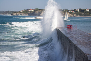 huge splash of wave against dike in Socoa, basque country