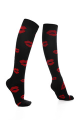 Close-up shot of a pair of high compression socks with red lips print. Black medical compression stockings for the prevention of varicose veins are isolated on a white background. Side view.