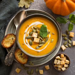 Pumpkin soup with bread in bowl - 780471438