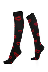 Close-up shot of a pair of high compression socks with red lips print. Black medical compression stockings for the prevention of varicose veins are isolated on a white background. Side view.