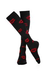 Close-up shot of a pair of high compression socks with red lips print. Black medical compression stockings for the prevention of varicose veins are isolated on a white background. Front view.