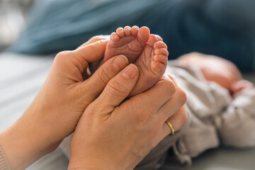 Tender Moments: Mother's Love Captured in Gentle Touch on Baby's Tiny Feet