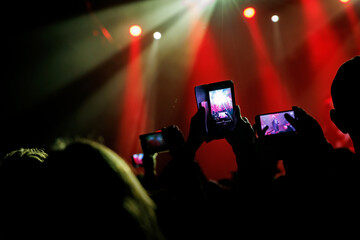 A mesmerizing moment unfolds at a live concert, recorded via mobile phone camera.