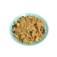 Blue-green plate with wheat muesli and oat flakes with chocolate on a white background