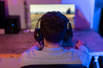Gamer immersed in racing game on PC