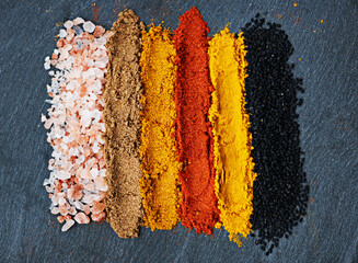 Row, spice and selection of powder for cooking, turmeric and paprika for meal. Top view, condiments...