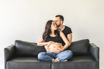 Pregnant woman sitting on floor with husband