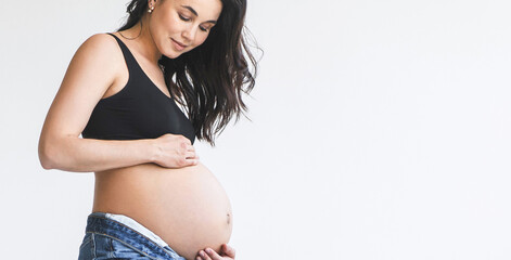 Pregnant woman in black top and jeans