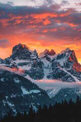 a mountain range with snow and clouds