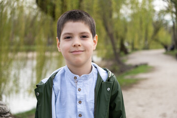 Portrait of 6 year old boy in spring park.