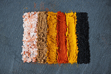 Row, spice and collection of powder for seasoning, turmeric and paprika for meal. Top view,...