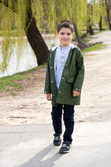 Six-year-old boy walking in spring park.