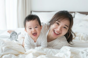 Fototapeta na wymiar A smiling mother and her laughing baby enjoying playtime on a white bed. Joyful Mother and Baby Playing on Bed