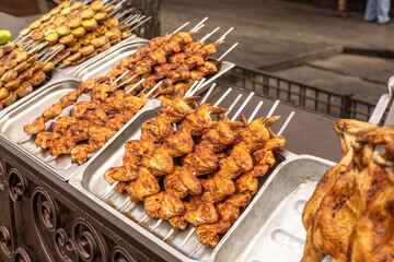 Street food stall. Roasted chicken , chicken and vegetables grilled on skewers