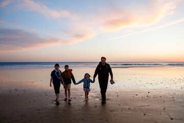 Portrait silhouettes of three children and dad happy kids with father on beach at sunset. happy...