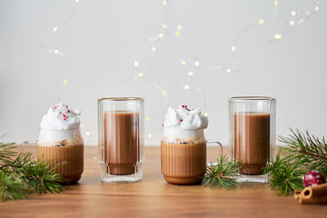 Four cups of hot chocolate on a wooden table