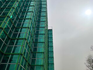 Fototapeta premium Glass green facade of office building. Milan, Italy