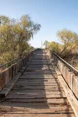 Weathered Wooden Boardwalk on Sand / Aged beach brown wooden floor over summer sand