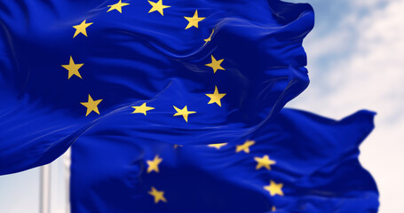 Close-up of the European Union flags waving on a clear day - 780509065