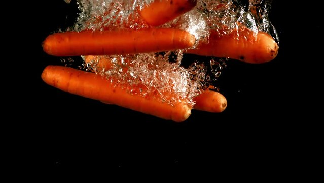 Super slow motion fresh carrots under water. High quality FullHD footage