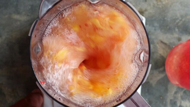 Top view of sharp splash peach water Shake. healthy organic peaches water shake slow motion 4k at 120fps