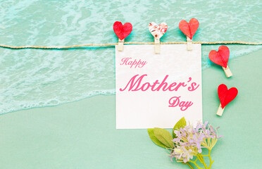 Happy Mother's day card with beach pattern background, greeting card with red heart and flower
