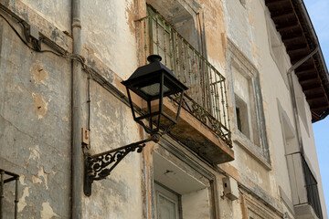 Vintage Street Lamp on Weathered Building Facade