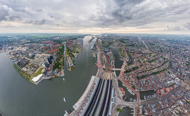 Amsterdam, Netherlands. Central Railway Station. Panorama of the city on a summer morning in cloudy...