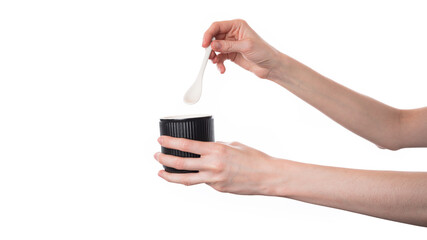 Person Holding Spoon Over Black Cup