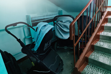 Storing baby strollers in the entrance of an apartment building.