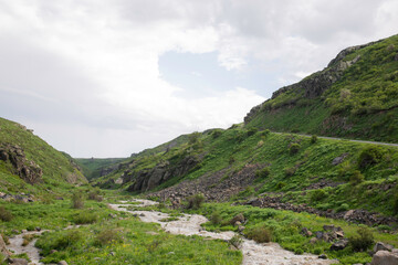 Fototapeta na wymiar Turbulent Full-flowing River In The Mountains Of Armenia