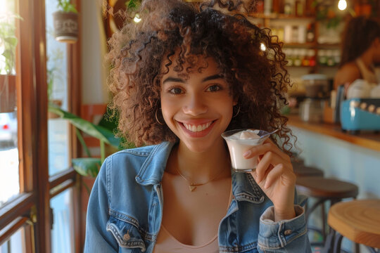 Radiant Young Woman Enjoying Coffee in a Cozy Cafe
