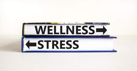 Wellness or stress symbol. Concept word Wellness or Stress on beautiful books. Beautiful white table white background. Healthy and Wellness or stress concept. Copy space. - obrazy, fototapety, plakaty