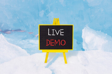Live demo symbol. Concept words Live demo on beautiful yellow black blackboard. Beautiful blue ice...