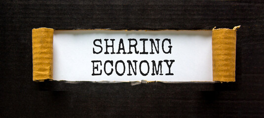Sharing economy symbol. Concept words Sharing economy on beautiful white paper. Beautiful black paper background. Business sharing economy concept. Copy space.