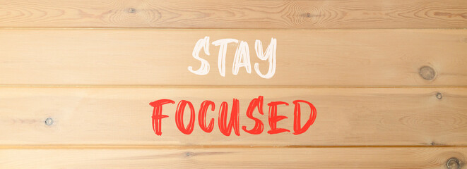 Stay focused symbol. Concept words Stay focused on beautiful wooden wall. Beautiful wooden wall background. Business, support, motivation, psychological stay focused concept. Copy space