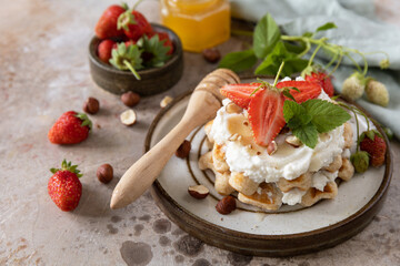Belgian waffles with fresh berrie strawberries and ricotta cheese for breakfast on a stone background. - 780552670