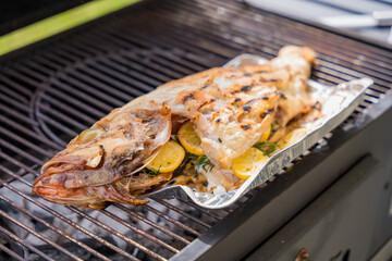 Whole grilled perch stuffed with lemon and rosemary
