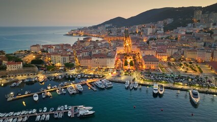 Aerial evening shot of Ajaccio old town, Corsica island. Flying over harbor, old houses and city...