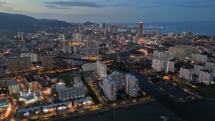 George Town, Penang, Malaysia with city lights. Flying over skyscrapers and avenues after sunset in GeorgeTown, Penang - 780555676