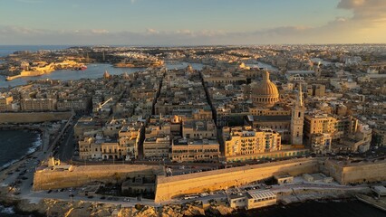 Flying over Valletta city, Malta. Aerial shot of Valletta old town in Malta during sunset - 780556459