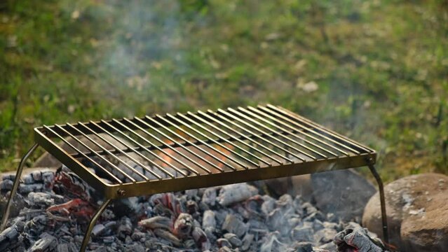 Close up of male hand put two sandwiches with cheese, tomatoes cooking on grill grate on bonfire at nature. Camping vibes and outdoor lifestyle mood concept