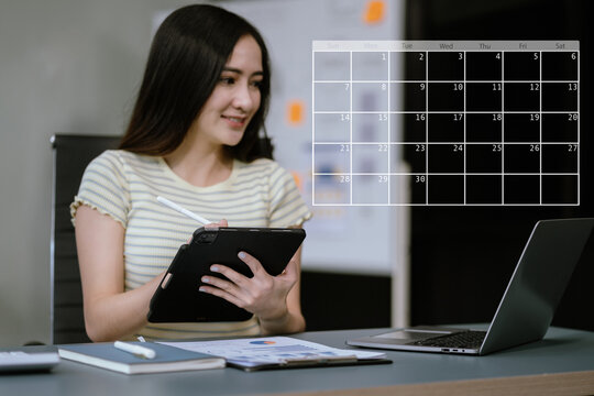 Business woman using digital tablet with calendar planner and organizer to plan and reminder, schedule, timetable, and management, event planning.