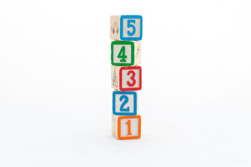 Colorful wooden blocks tower with 5, 4, 3, 2, and 1 numbers isolated on white background