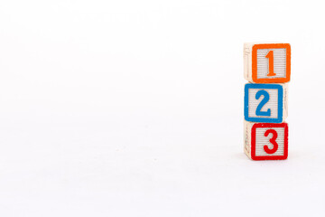 Wooden blocks with 1, 2 and 3 number isolated on white background with copy space.