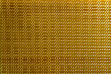 Background texture and pattern of section voshchina of wax honeycomb from a bee hive for filled with honey. Voshchina an artificial basis for the construction of honeycombs, sheet of wax of cells
