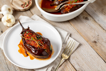 Roasted stuffed eggplant with tomato sauce on a plate