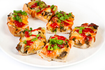 Toasted open-face sandwich made of a sliced baguette  topped with white mushrooms, cheese and ketchup, zapiekanki
