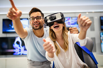Happy woman and man with virtual reality VR glasses. Future technology fun friend concept. - 780592648