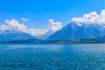 View of the Annecy lake surrounded by beautiful mountains in Annecy, France